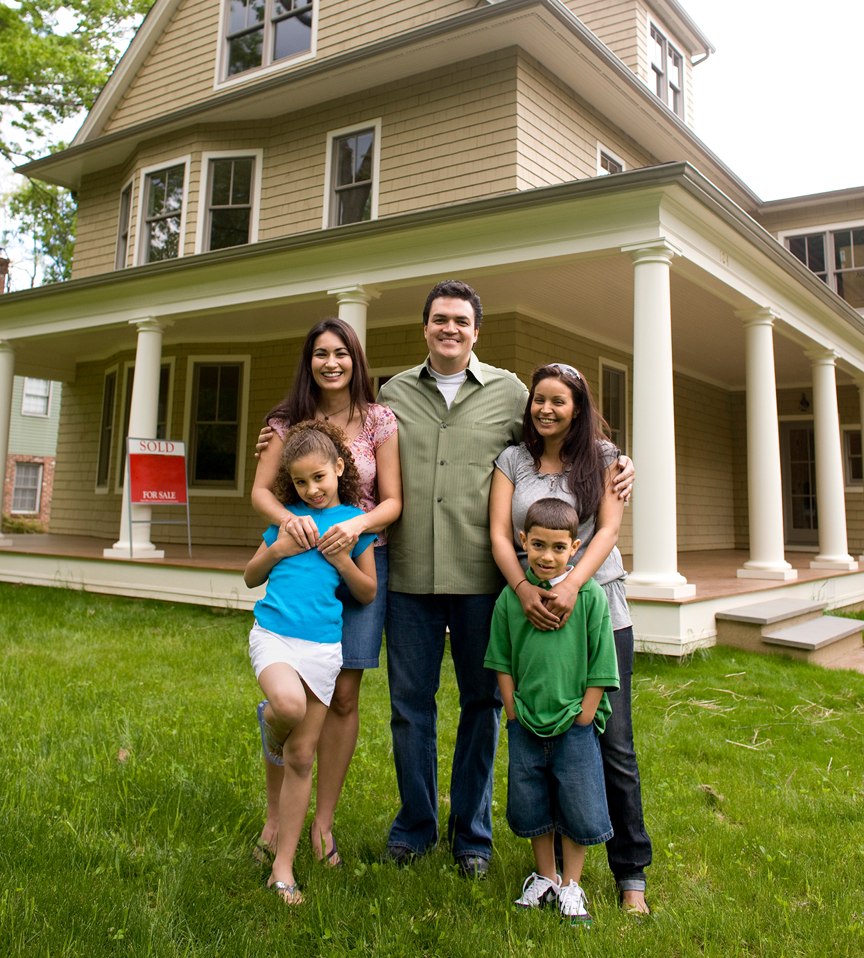 Family standing in front of their home.
