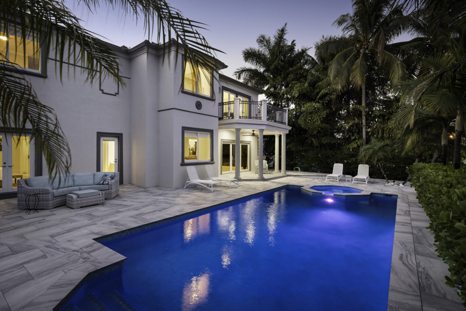 Elegant villa featuring a blue swimming pool.