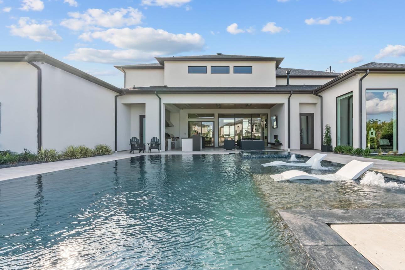 Modern house with large outdoor swimming pool.