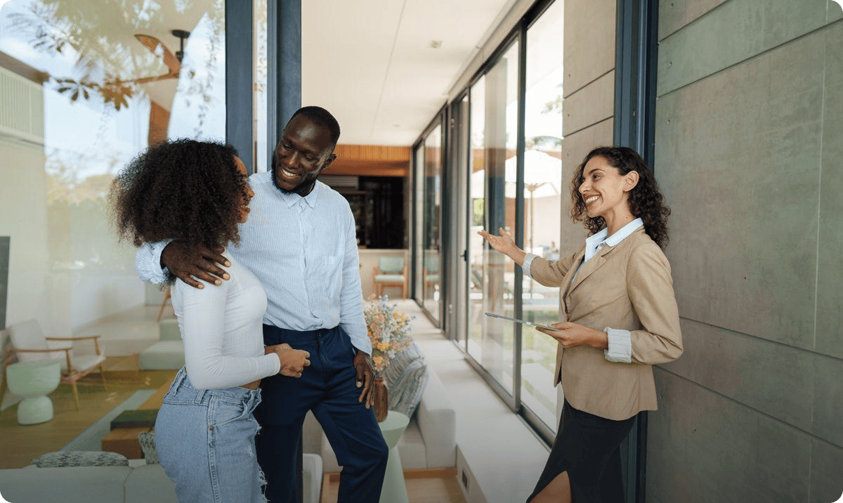 Couple viewing home with real estate agent.