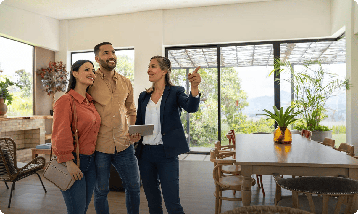 Real estate agent showing couple modern home.